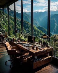 a desk in front of a large window overlooking mountains