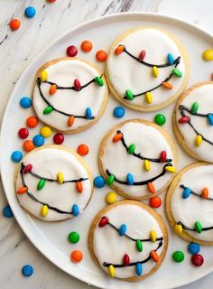 cookies decorated with icing and colored candies on a plate