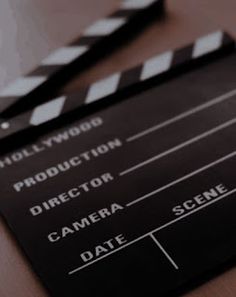 a movie clapper sitting on top of a wooden table