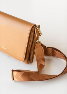 The Recycled Vegan Leather Crossbody Bag is a compact crossbody that is perfect for any occasion! Wear it as a shoulder bag, crossbody, or carry as a clutch! Made with recycled water bottle lining, with a foldover flap with magnetic button closure. This bag has all the pockets with two interior sections, two interior slip pockets, an exterior back zip pocket! It comes with two detachable, adjustable crossbody straps 1 vegan leather, 1 woven for a variety of looks! Style | Bags Color | Tan Material | Recycled Vegan Leather Dimensions | L 8.5” x H 6.5” x D 1.5” Brown Flap Bag With Fold Over Clasp For Everyday, Everyday Brown Flap Bag With Fold Over Clasp, Rectangular Flap Bag With Magnetic Closure For On-the-go, Travel Crossbody Flap Bag With Fold Over Clasp, Everyday Flap Clutch Bag With Magnetic Closure, Everyday Crossbody Shoulder Bag With Fold Over Clasp, Trendy Everyday Flap Bag With Magnetic Closure, Everyday Clutch Flap Bag With Magnetic Closure, Everyday Magnetic Closure Clutch Flap Bag