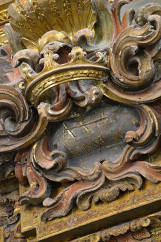 an ornate gold and black clock on display