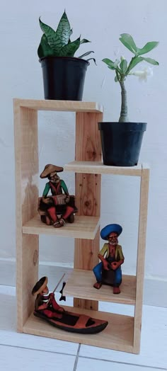 three wooden shelves with toy figurines on them and a potted plant in the background