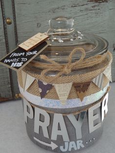 a glass jar with a tag on it that says pray