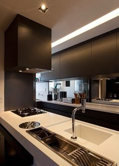 modern kitchen with white counter tops and black cabinets