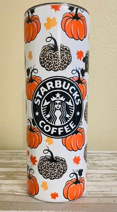 a starbucks cup with pumpkins and leopard print on it