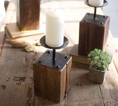 three candles sitting on top of wooden blocks