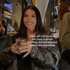 a woman holding a glass in her hand with the words shine, girl, not because you have to prove anything, but because you already are everything