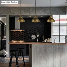 a kitchen with two stools and an island in front of the counter top is shown