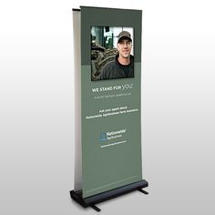 a roll - up banner with a photo of a man in black shirt on it