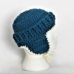 a crocheted hat on a mannequin head