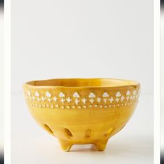 two pictures of a yellow bowl with white designs on it