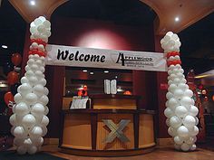 a welcome arch made out of balloons at an event