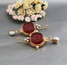 ✽ D E T A I L S   {Gemstone} - Red Glass   {Gemstone Size} - 18 mm    {Earring Height Including Hoop} - 5.5 cm   {Earring Width} - 2.8 cm   {Finish} - Smooth and high polished with brilliant shine.   {Note} -The earrings are made to order, production day is about 3-5 working days. The one you receive may be slight different from the one                  in the picture due to handmade nature, but it will be almost same as in the above picture.    These pieces are handcrafted from start to finish Temple Jewelry Earrings As Gift, Temple Jewelry Style Bridal Earrings As A Gift, Yellow Gold Temple Jewelry Pearl Earrings, Red Oval Wedding Earrings, Handmade Red Pearl Earrings For Wedding, Handmade Red Pearl Wedding Earrings, Traditional Pearl Gemstone Earrings For Gift, Elegant Oval Earrings As Gift, Round Temple Jewelry Earrings