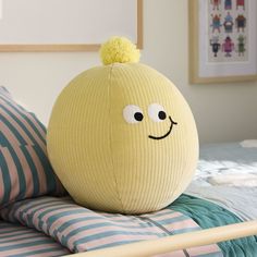 a yellow ball sitting on top of a bed