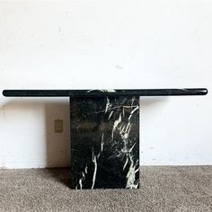 Introduce timeless elegance to your home with this Italian Black Marble Console Table. Crafted with meticulous attention to detail, this table features a rectangular top with rounded edges, exuding a sense of refined sophistication. The sleek black marble surface offers a luxurious feel and a striking visual contrast against any decor. Supported by a sturdy rectangular pedestal base crafted from the same exquisite marble, this console table combines functionality with sculptural beauty. Whether Modern Console Tables Living Room, Black Marble Console Table, Marble Console Table Entryway, Black Marble Console, Italian Console Table, Extra Long Console Table, Console Table Entryway, Reclaimed Beams, Masculine Interior