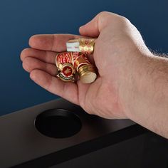 a person holding some type of candy in their left hand with the other hand on top of it