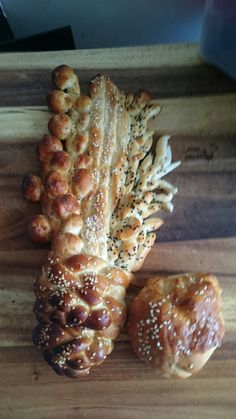 breads and rolls on a cutting board with sesame seed sprinkles in the middle