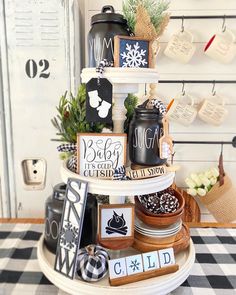 a three tiered cake stand with black and white decorations