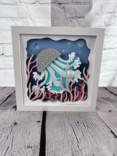 a card with an image of a jellyfish in the water and corals on it