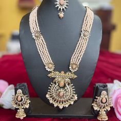 The Ira Necklace Set by Vama Designs is a showstopper and apt for adding royalty to any wedding or festive look. The set has a multi-layered pearl necklace with detailed work on it, complemented perfectly with Jhumar and statement earrings and a matching maang tikka. Delicate craftsmanship in a soft pastel tone makes this set apt for traditional and modern outfits, bringing in that elegance and sophistication into your outfit. Key Features: Multi-Layered Pearl Necklace: This beautiful piece comp Formal Kundan Jewelry Sets With Chandbali Design, Formal Kundan Jewelry Sets Chandbali Style, Elegant Designer Chandbali Jhumkas, Elegant Designer Stone Work Jhumkas, Elegant Jewelry Sets With Stone Work For Designer Wear, Elegant Designer Jewelry Sets With Stone Work, Elegant Kundan Necklace With Pearl And Stone Work, Elegant Kundan Pearl Necklace With Stone Work, Temple Jewelry Pearl Chandbali Sets