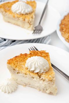 a slice of pie with whipped cream on top sits on two white plates and is ready to be eaten