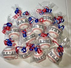 a bunch of baseballs wrapped in plastic and tied with red white and blue ribbons