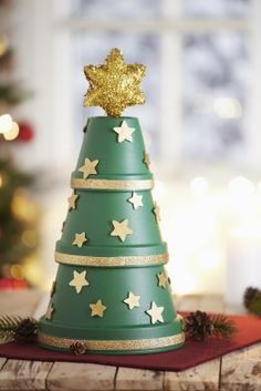 a green christmas tree with gold stars on top