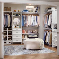 a walk in closet with white drawers and shelves filled with clothing, shoes and other items