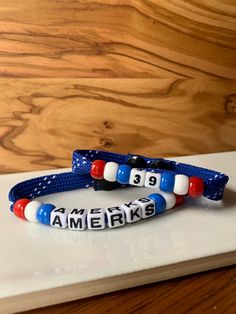 two bracelets with the word america on them are sitting on a white counter top