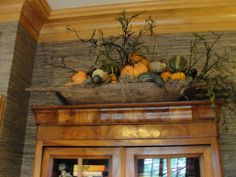 a bunch of pumpkins sitting on top of a wooden shelf