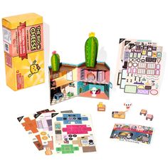 an assortment of stickers and magnets in a box with a cactus on top