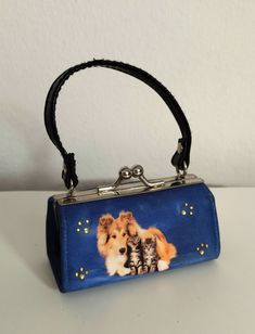 This cute little makeup bag in a beautiful, strong azure blue comes from a collection. Bag is visibly unused Practical clip closure Well-made inner lining Outside photo print on fine fabric with a Colli dog and two cute kittens. Glitter stones on one side of the makeup bag. Can also be used as a wallet for small change. Very nice, well-maintained condition. No damage to the fabric. Minimal signs of wear present Size approx. 9 x 5 cm TAKE A LOOK IN MY SHOP. Great and unique bargains are waiting t Blue Rectangular Case Shoulder Bag For Gift, Compact Blue Bags For Daily Use, Blue Mobile Phone Evening Bag, Blue Rectangular Cosmetic Bag For Gifts, Blue Pouch Evening Bag For Gift, Blue Rectangular Cosmetic Bag As Gift, Blue Rectangular Cosmetic Bag Gift, Blue Rectangular Gift Cosmetic Bag, Blue Rectangular Evening Bag For Mobile Phones