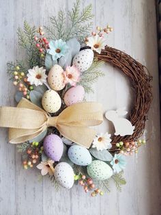 an easter wreath with eggs and flowers