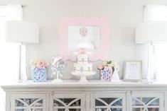 a baby's first birthday cake on top of a dresser