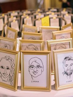 a table topped with framed pictures and portraits of people's faces on paper towels