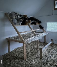 a wooden bench sitting in the middle of a room with stuffed animals on top of it