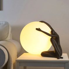 a lamp sitting on top of a table next to a couch