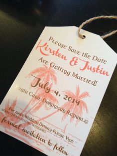 a wedding save the date card hanging from a string