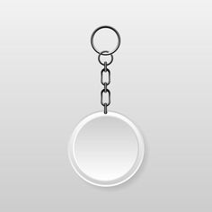 a round metal keychain with a chain hanging from it's center on a gray background