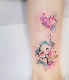 an elephant holding a heart shaped balloon tattoo on the right side of the leg with watercolor splashs