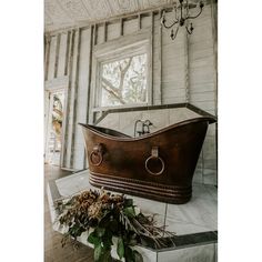 an old fashioned bathtub sitting in the middle of a room