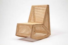 a chair made out of wicker sitting on top of a white floor