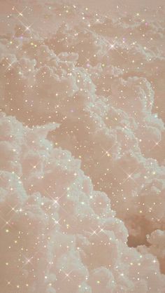 the sky is filled with lots of white clouds and sparkles in pink hues