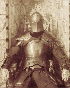 an old photo of a man in armor