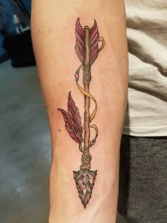 a tattoo on the arm of a woman with an arrow and bow in her hand