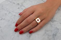 "This is an impressive 14k gold and garnet signet ring. It is made of 14k//18k gold (per your choice), and there is a red garnet set in its center, in a beautiful rhombus inlay, to add to its luxurious, unique style. Get this elegant gold square signet ring for your loved one, or yourself, to upgrade every outfit you own with a meaningful, timeless, shiny and impressive piece of jewelry. ✿ Item details ✿ ✿ Materials: - 14k/18k Yellow//Rose//White Gold (per your choice) - A red garnet of 0.50CT; Luxury Red Heirloom Signet Ring, Gold Ruby Signet Ring With Polished Finish, Heirloom Red Gold Signet Ring, Classic 14k Gold Red Signet Ring, Classic Red 14k Gold Signet Ring, Red 14k Gold Signet Ring, 14k Gold Red Signet Ring For Anniversary, Modern 14k Gold Red Rings, Gold Garnet Signet Ring For Formal Occasions