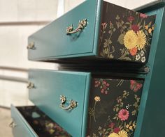 three drawers with flowers painted on them