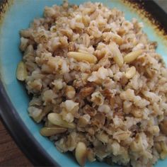 a blue plate topped with rice and nuts