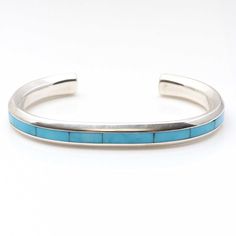 Exquisite turquoise inlay technique by Zuni silversmith Johnathon Natachu is displayed in this attractive sterling silver bracelet. Just over 1/4" wide and 5 " inside tip to tip with a 1 gap this bracelet will fit a wrist circumference of up 6 ". This bracelet is not adjustable. Weight approximately 34.4 grams. Turquoise Sterling Silver Cuff Bracelet With Polished Finish, Turquoise Sterling Silver Cuff Bracelet With Inlay, Sterling Silver Turquoise Cuff Bracelet With Inlay, Handmade Turquoise Jewelry, Turquoise Cuff, Sterling Silver Bracelet, Turquoise Jewelry, Sterling Silver Bracelets, Silver Bracelet