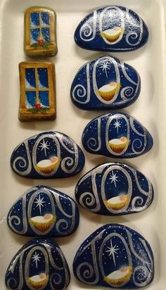 some blue and white rocks with cupcakes on them in front of a window